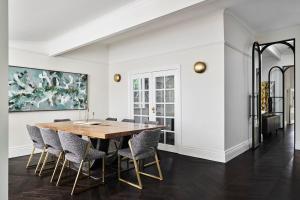 a dining room with a wooden table and chairs at Bendigo Signature Accommodation Wattle Street in Bendigo