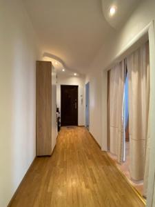 an empty hallway with wood floors and a door at 3-badroom flat near the sea with 12 places to sleep in Sychavka