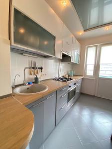 a kitchen with a sink and a counter top at 3-badroom flat near the sea with 12 places to sleep in Sychavka