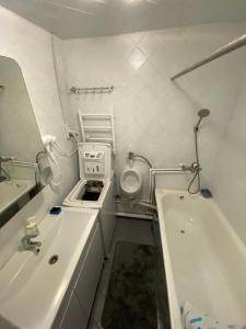 a bathroom with a sink and a toilet and a tub at 3-badroom flat near the sea with 12 places to sleep in Sychavka +22 photos