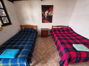 Postel nebo postele na pokoji v ubytování Hospedaje Altamira Villa de Leyva