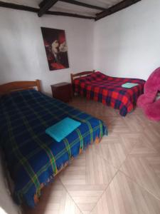 Postel nebo postele na pokoji v ubytování Hospedaje Altamira Villa de Leyva