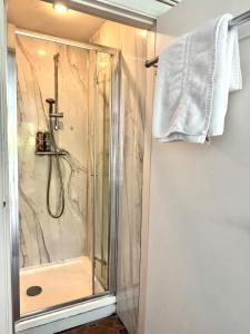 a shower in a bathroom with a glass shower stall at Worthing - Garden Pad with FREE on street PARKING in Worthing