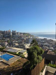a view of a city with a swimming pool and the ocean at Arka Hotel in Viña del Mar +33 photos