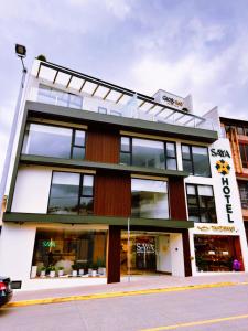 a large building with windows on a street at Saya Hotel & Suites in Cuenca