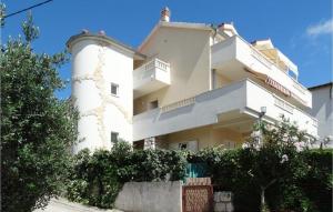a white building with a tower in front of it at Lovely Apartment In Omis With Wifi in Tice