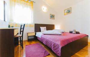 a bedroom with a bed with a pink blanket at Lovely Apartment In Omis With Wifi in Tice
