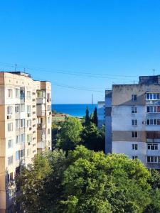 a view of two tall buildings and the ocean at 3-badroom flat near the sea with 12 places to sleep in Sychavka