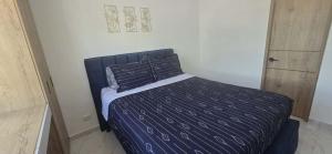 Postel nebo postele na pokoji v ubytování Maravilloso Apartamento Ricaurte + 7 fotografií