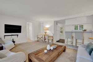 a living room with a couch and a table at Elsewhere on Madison Square Carriage House in Savannah