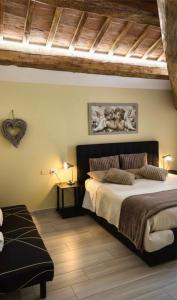 a bedroom with a large bed and a wooden ceiling at Appartamento "IL PORTICO" a pochi minuti da IMOLA e FAENZA in Imola +14 photos