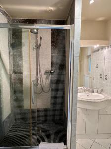 a bathroom with a shower and a sink at Château Le Baudou in Coutras +48 photos
