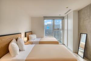 Postel nebo postele na pokoji v ubytování Nido Nomad Las Américas GDL + 63 fotografií