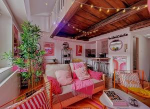 a living room with a couch and a table at Blush Heaven - Wifi - Netflix in Nancy