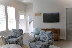 een woonkamer met 2 stoelen en een flatscreen-tv bij 404A The Hilltop House in Virginia Beach