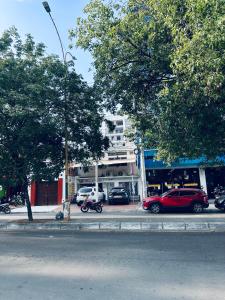 a red car parked on the side of a street at Habitacion privada cerca al hospital de Neiva con Aire Acondicionado y baño Privado in Neiva +2 photos