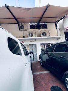 two cars parked in front of a garage at Habitacion privada cerca al hospital de Neiva con Aire Acondicionado y baño Privado in Neiva
