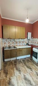 an empty kitchen with wooden cabinets and a sink at full moon in Yerevan