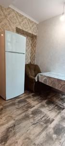 a living room with a refrigerator and a couch at full moon in Yerevan