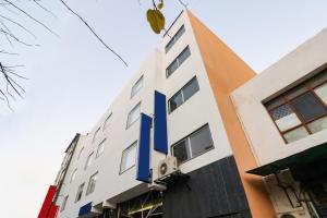 a building with a blue sign on the side of it at Hotel O Lax in New Delhi