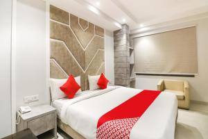 a bedroom with a large bed with red pillows at Hotel Premium Suites Near Delhi Airport in New Delhi +83 photos