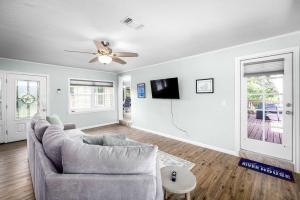 a living room with a couch and a ceiling fan at Riverfront Private Deck Family Games Wurstfest Fun in Seguin