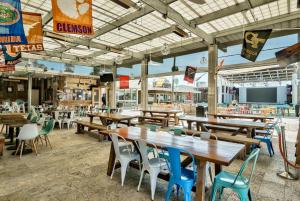 an empty restaurant with wooden tables and chairs at Prominence Southside - Blue Skies in Watersound Beach