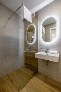 a bathroom with a sink and a shower at Premier Nova Residence in Novi Sad