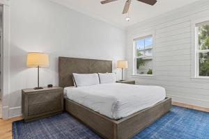 a bedroom with a large bed with two lamps at Crabbing Hole Lane in Rosemary Beach +51 photos
