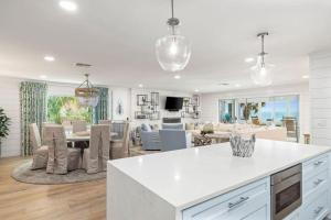 a kitchen and living room with a table and chairs at Seaside Retreat in Santa Rosa Beach