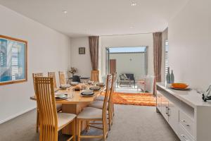 a kitchen and dining room with a table and chairs at Stay Central Taupo in Taupo