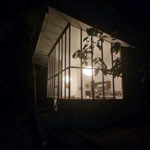 a window of a building with a light in it at La Rana De Cahuita in Cahuita