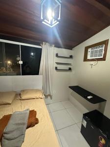 Ένα ή περισσότερα κρεβάτια σε δωμάτιο στο Hospedagem do Centro