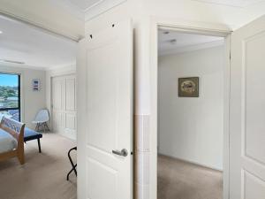 an open door in a room with white walls at Beachside Retreat with Garage Parking in Surf Beach