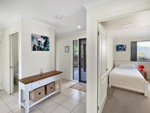 a bedroom with a bed and a desk at Beachside Retreat with Garage Parking in Surf Beach +21 photos