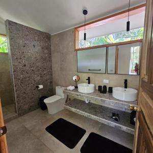 a bathroom with two sinks and a mirror at La Rana De Cahuita in Cahuita +45 photos