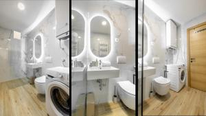 a bathroom with a toilet sink and a washing machine at Premier Nova Residence in Novi Sad +47 photos