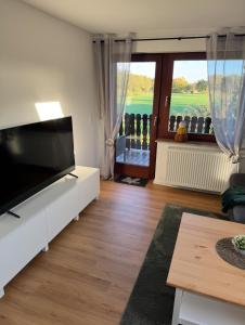 a living room with a large flat screen tv at Ferienwohnung Fehnzeit in Rhauderfehn