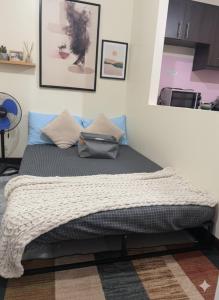 a bed in a room with at BGC Mckinley Center Prime Accommodations in Manila