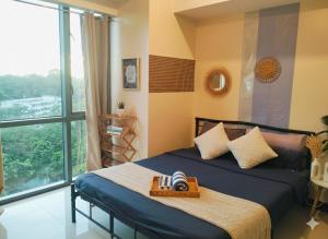 a bedroom with a bed and a large window at BGC Mckinley Center Prime Accommodations in Manila +56 photos