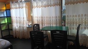 a table and chairs in a room with curtains at cabañas del inka in Puno +9 photos