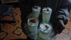 four drinks on a glass plate on a table at cabañas del inka in Puno