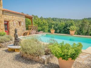a pool in a yard with plants and a house at Mas dAmour in Montcabrier