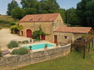 an external view of a building with a swimming pool at Mas dAmour in Montcabrier