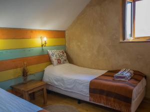 a small bedroom with two beds and a window at Mas dAmour in Montcabrier +22 photos