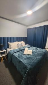 a bedroom with a bed with two towels on it at Essencial Hotel Spa in Mendoza