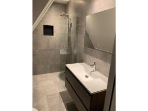 a bathroom with a sink and a shower at by the water in Friesland NI in Stavoren +20 photos