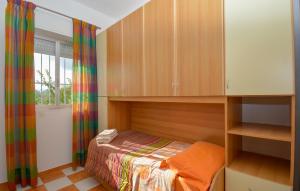 a small bedroom with a bed and a window at Stunning Home In Comiso With Wifi in Comiso Airport