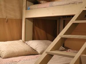 a set of bunk beds with a bunk bed in a room at Luxury Family Tent with Play Area in Balkbrug
