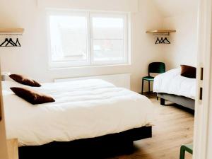 a bedroom with two beds and a window at Luxury holiday home in Zwevezele in Lichtervelde